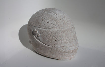 Left side angle of custom-made mini Formula 1 helmet designed with a white natural stone effect. The helmet, crafted to emulate natural stone with a matte finish, adds a sleek and modern touch to any home decor. Available for purchase with customization options on the website.